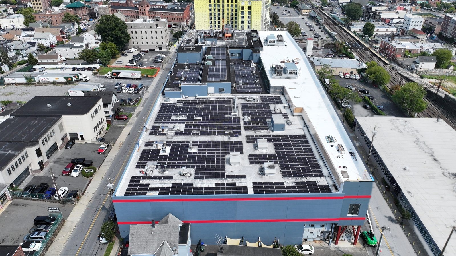 Aerial view of a commercial bakery rooftop covered in solar panels, Port Chester, New York