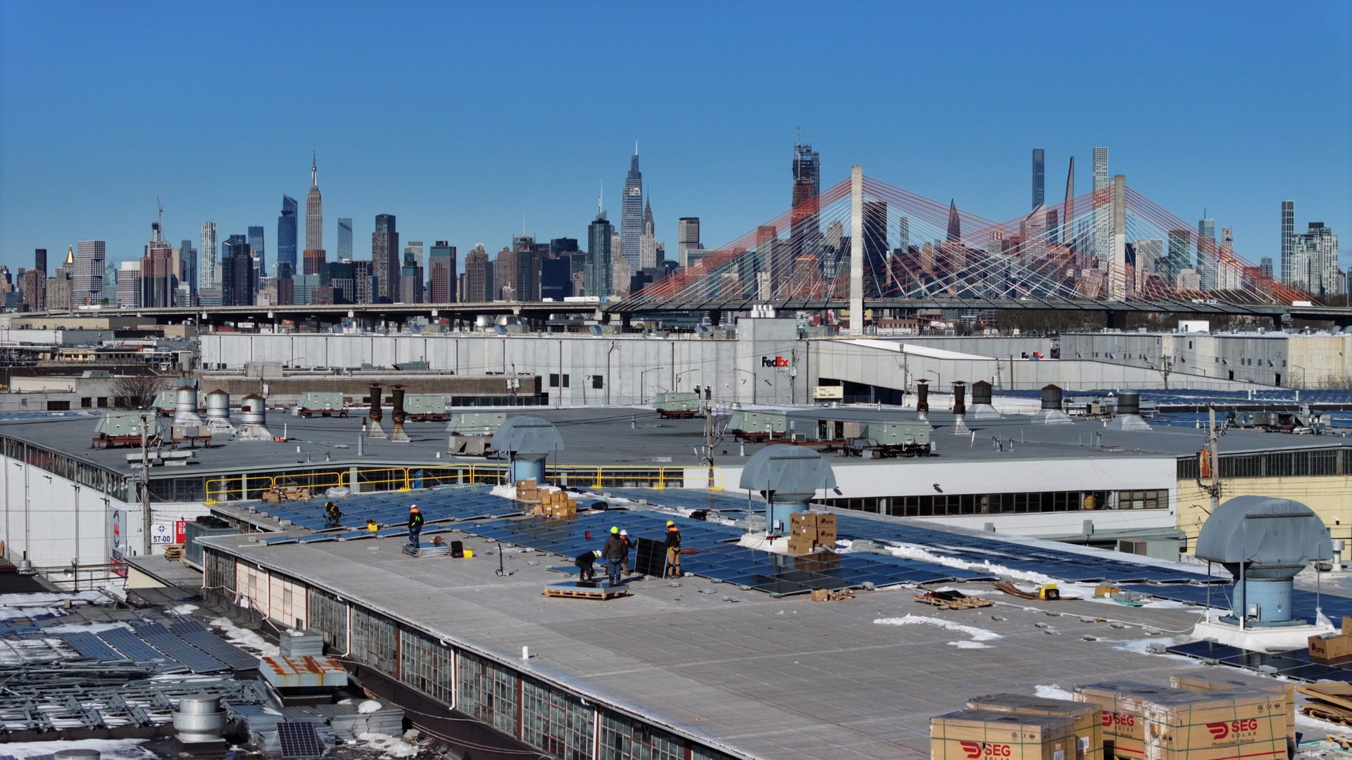 Bliss Solar crew on a Queens rooftop with the Manhattan skyline behind