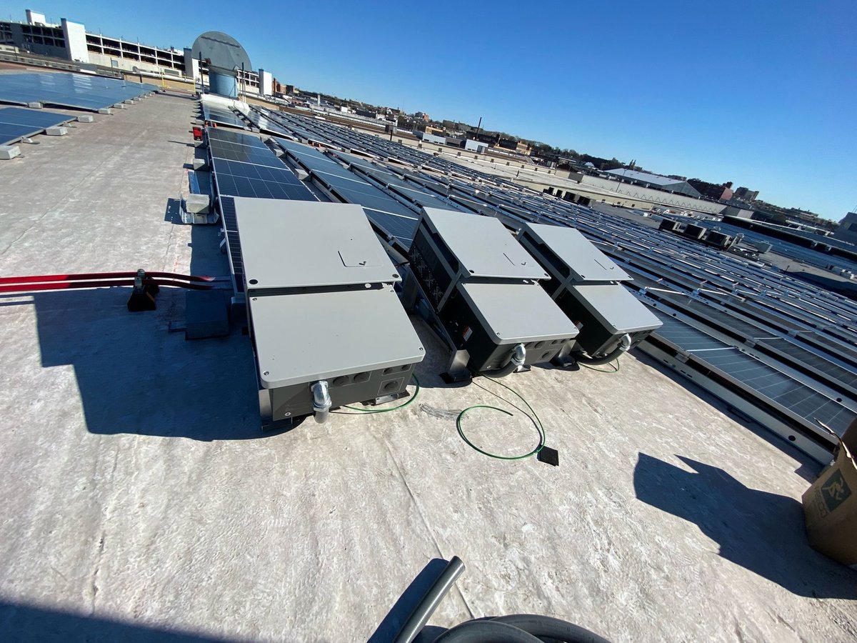 Inverters staged on a rooftop before mounting
