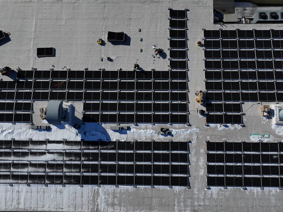 Top-down drone view of a rooftop solar array in Queens