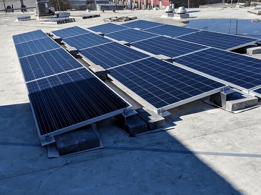 Rooftop solar panels with the Manhattan skyline in the distance